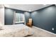 Bedroom featuring a gray accent wall, a window, and a classic arm chair at 10906 Pastel Pt, Parker, CO 80134