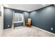 Bedroom features a gray accent wall, a window, and a classic arm chair at 10906 Pastel Pt, Parker, CO 80134
