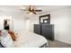 Bedroom featuring a ceiling fan and dresser with decorative mirror hanging above at 10906 Pastel Pt, Parker, CO 80134