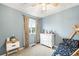 Light blue bedroom features a dresser, curtains, and a fun ceiling fan at 10906 Pastel Pt, Parker, CO 80134
