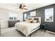 A sunlit bedroom with a ceiling fan, with a dresser and decor against the wall at 10906 Pastel Pt, Parker, CO 80134