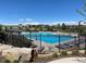 Bright community pool featuring a playground, lounge chairs, and lush landscaping, ideal for Gathering fun at 10906 Pastel Pt, Parker, CO 80134