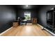 Home office featuring a modern desk, ergonomic chair, and workout equipment in a dark colored room at 10906 Pastel Pt, Parker, CO 80134