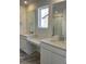 Dual-sink bathroom with countertop space, large mirrors, white cabinets, and tile flooring at 728 N Clubview St, Watkins, CO 80137