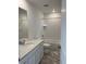 Well-lit bathroom features a tub and shower, decorative tiles, and stylish vanity with a light countertop at 728 N Clubview St, Watkins, CO 80137