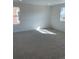 Well-lit carpeted bedroom with two windows providing ample daylight, offering a comfortable and inviting space at 728 N Clubview St, Watkins, CO 80137