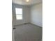 Carpeted bedroom featuring a window that provides an exterior view and natural lighting at 728 N Clubview St, Watkins, CO 80137