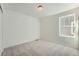 Neutral bedroom featuring soft carpet, large window, and ample natural light at 728 N Clubview St, Watkins, CO 80137