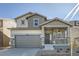 Charming two-story home with stone accents, covered porch, and two car garage at 728 N Clubview St, Watkins, CO 80137