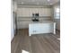 Bright kitchen with stainless appliances, white cabinets, and a large island at 728 N Clubview St, Watkins, CO 80137