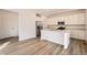 Contemporary kitchen featuring stainless steel appliances, a center island, and hardwood floors at 728 N Clubview St, Watkins, CO 80137