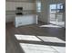 Bright kitchen with stainless appliances, white cabinets, and a large island at 728 N Clubview St, Watkins, CO 80137