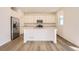 Modern kitchen with stainless steel appliances, large island, and ample cabinet space at 728 N Clubview St, Watkins, CO 80137