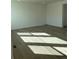Bright and airy living room showcasing wood floors, white walls, and natural light streaming through the windows at 728 N Clubview St, Watkins, CO 80137