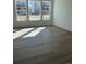 Bright living room featuring gleaming wood floors and an abundance of natural light at 728 N Clubview St, Watkins, CO 80137