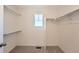 Bright walk-in closet with shelving and a small window providing natural light at 728 N Clubview St, Watkins, CO 80137