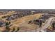 Expansive aerial view showcases a suburban neighborhood bordering a golf course at 21753 E Heritage Pkwy, Aurora, CO 80016
