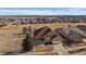 Aerial view of a brown single Gathering home in a neighborhood in a golf community at 21753 E Heritage Pkwy, Aurora, CO 80016