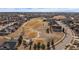 Expansive aerial view showcases a suburban neighborhood bordering a golf course at 21753 E Heritage Pkwy, Aurora, CO 80016
