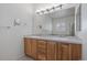 Well-lit bathroom featuring dual sinks and a large mirror, providing ample space at 21753 E Heritage Pkwy, Aurora, CO 80016