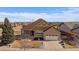 Charming two-story home with a well-maintained lawn and attached two-car garage and covered porch at 21753 E Heritage Pkwy, Aurora, CO 80016