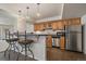 The kitchen features wood cabinets, stainless steel appliances, and stone countertops, creating a functional and modern space at 21753 E Heritage Pkwy, Aurora, CO 80016