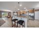 Gourmet kitchen with granite countertops, stainless steel appliances, and an island with bar seating at 21753 E Heritage Pkwy, Aurora, CO 80016