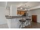 Cozy kitchen with wood cabinets, stone countertop, and barstool seating, perfect for casual dining and entertaining at 21753 E Heritage Pkwy, Aurora, CO 80016