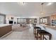 Open-concept living room featuring a fireplace, tile flooring and a view of the kitchen and backyard deck at 21753 E Heritage Pkwy, Aurora, CO 80016