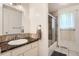 Bathroom featuring a marble-style vanity countertop, sliding glass shower door, and neutral walls at 2310 Squires Ct, Longmont, CO 80501