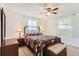 Cozy bedroom with a large bed, ceiling fan, and bright natural light coming through the windows at 2310 Squires Ct, Longmont, CO 80501
