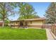 Charming single-story home with a well-maintained lawn, inviting patio, and a peaceful backyard setting at 2310 Squires Ct, Longmont, CO 80501
