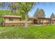 Back exterior view of a well-maintained single-story home, with a covered patio perfect for relaxing at 2310 Squires Ct, Longmont, CO 80501