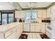 Functional kitchen with white appliances, ample countertop space, and tile flooring for easy cleanup at 2310 Squires Ct, Longmont, CO 80501