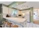 Well-maintained kitchen featuring white cabinets, a breakfast bar, and lots of countertop space for cooking at 2310 Squires Ct, Longmont, CO 80501