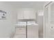 Laundry room with a washer and dryer, overhead storage, and neutral colors at 2310 Squires Ct, Longmont, CO 80501