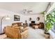 Bright living room with plush leather furniture, a ceiling fan, and large windows providing natural light at 2310 Squires Ct, Longmont, CO 80501