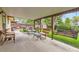 Inviting covered patio with wicker furniture and a wooden swing, perfect for outdoor relaxation and entertaining at 2310 Squires Ct, Longmont, CO 80501