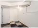 Unfinished basement with paneled door, lighting fixture, and neutral walls at 2310 Squires Ct, Longmont, CO 80501