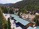 Aerial view of condo building, parking area, and beautiful views of mountains and trees at 4192 Highway 9 # 3, Breckenridge, CO 80424