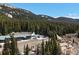 Aerial view of condo building nestled amongst trees with mountains at 4192 Highway 9 # 3, Breckenridge, CO 80424
