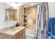 Bathroom featuring a single sink vanity, shower with a tub, and decorative tile at 4192 Highway 9 # 3, Breckenridge, CO 80424