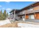 Two-story condo building with multiple decks and exterior entrance, plus snowy ground at 4192 Highway 9 # 3, Breckenridge, CO 80424