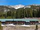 Exterior of two-story condos with mountain backdrop, snow and trees at 4192 Highway 9 # 3, Breckenridge, CO 80424