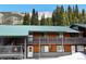 Exterior of condo building with snow, trees, and mountain in background at 4192 Highway 9 # 3, Breckenridge, CO 80424