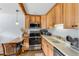 Cozy kitchen featuring stainless steel appliances, white countertops, and rustic wood beam at 4192 Highway 9 # 3, Breckenridge, CO 80424