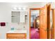 Bright bathroom featuring a single sink vanity and a medicine cabinet with an open door to the bedroom at 4034 S Atchison Way, Aurora, CO 80014