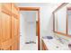 Bright bathroom with a large vanity, medicine cabinet, and view into another room with tile floors at 4034 S Atchison Way, Aurora, CO 80014