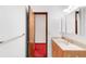 Bathroom featuring a single sink vanity, a medicine cabinet, and an open door to another room at 4034 S Atchison Way, Aurora, CO 80014