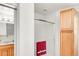 Bright bathroom with a tiled shower, glass door, and wood cabinet at 4034 S Atchison Way, Aurora, CO 80014